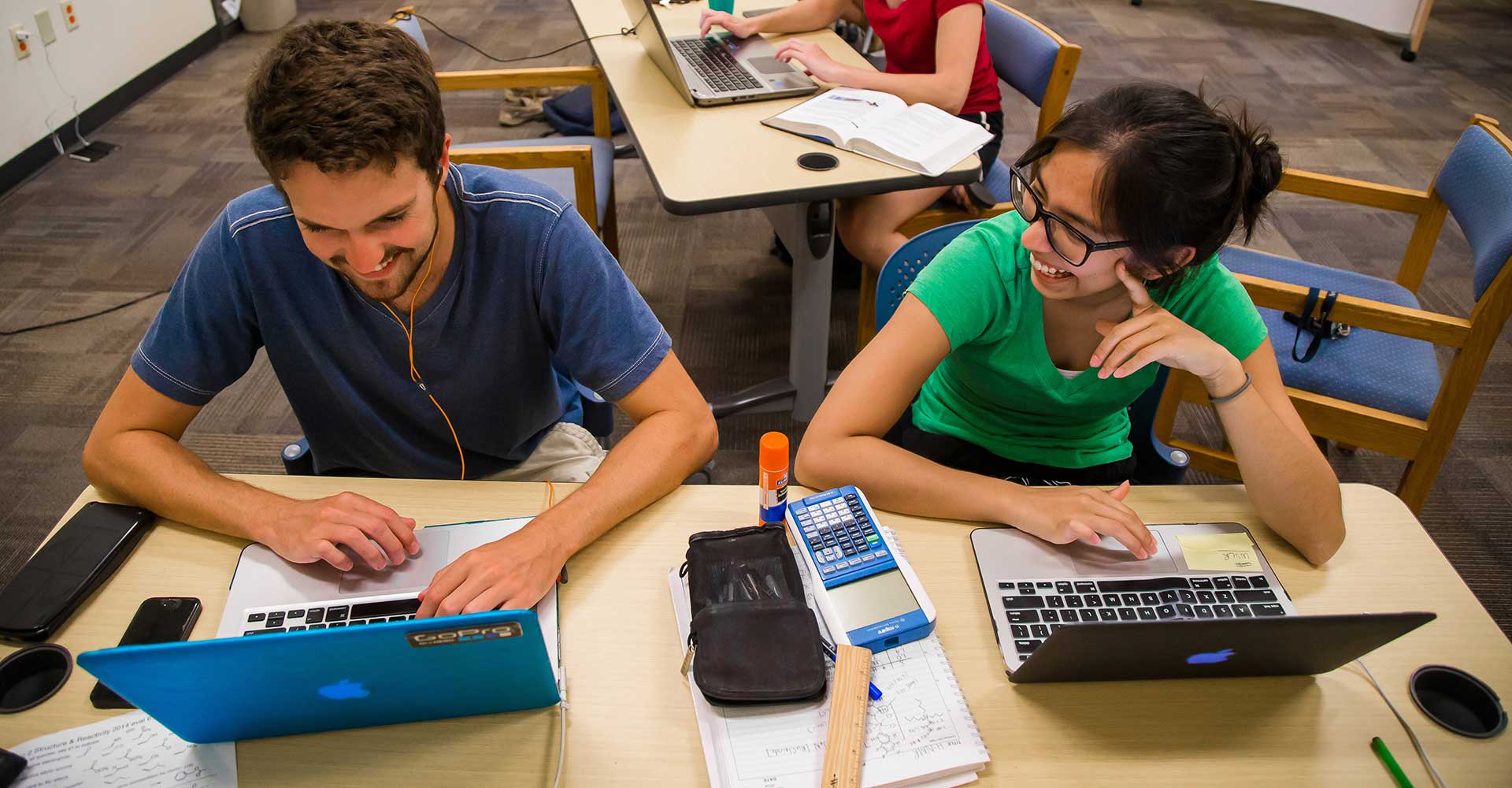 students in a classroom on a laptop